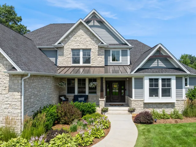 a view of a brick house with large windows