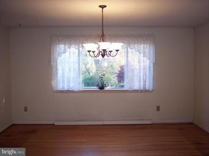 115 Ashton Road Ashton, MD 20861 - Photo 11 of 25 a view of a room with wooden floor chandelier and windows
