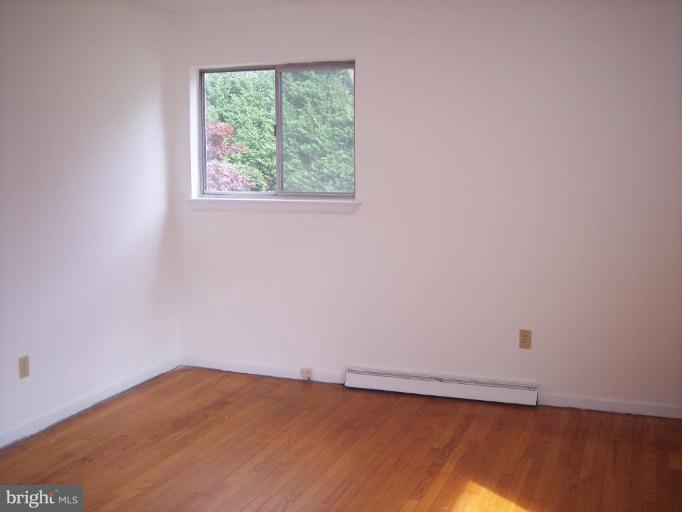 115 Ashton Road Ashton, MD 20861 - Photo 17 of 25 a view of an empty room with wooden floor and a window