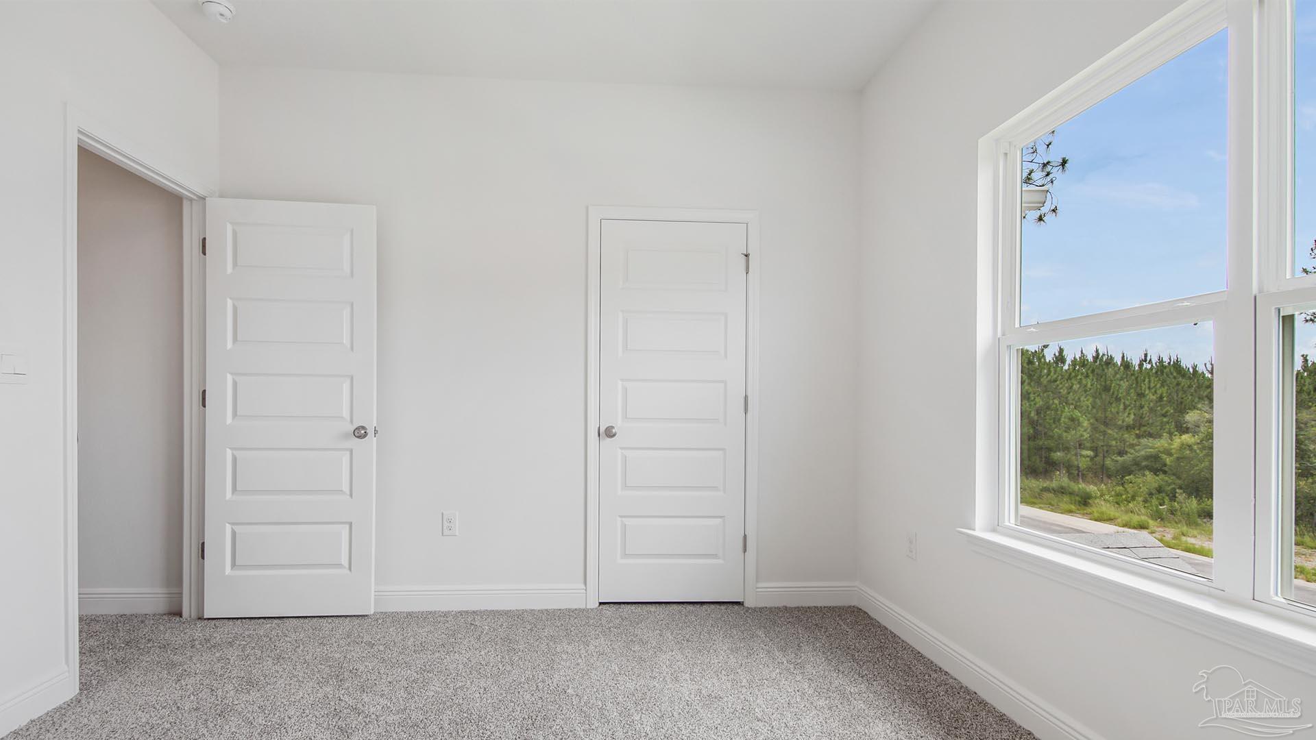 3233 Harrier Road Pace, FL 32571 - Photo 26 of 50 an empty room with windows and closet