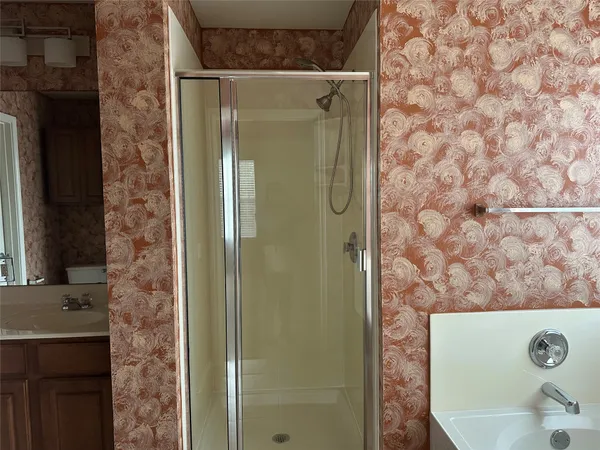 a bathroom with a bathtub and shower