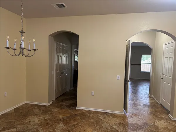 a view of a livingroom with wooden floor and a chandelier