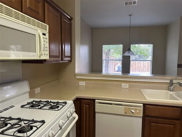 a kitchen with a stove a sink and a microwave