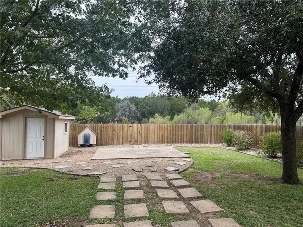 a view of a backyard with a small cabin