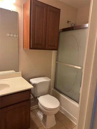 a white toilet sitting next to a bathroom sink