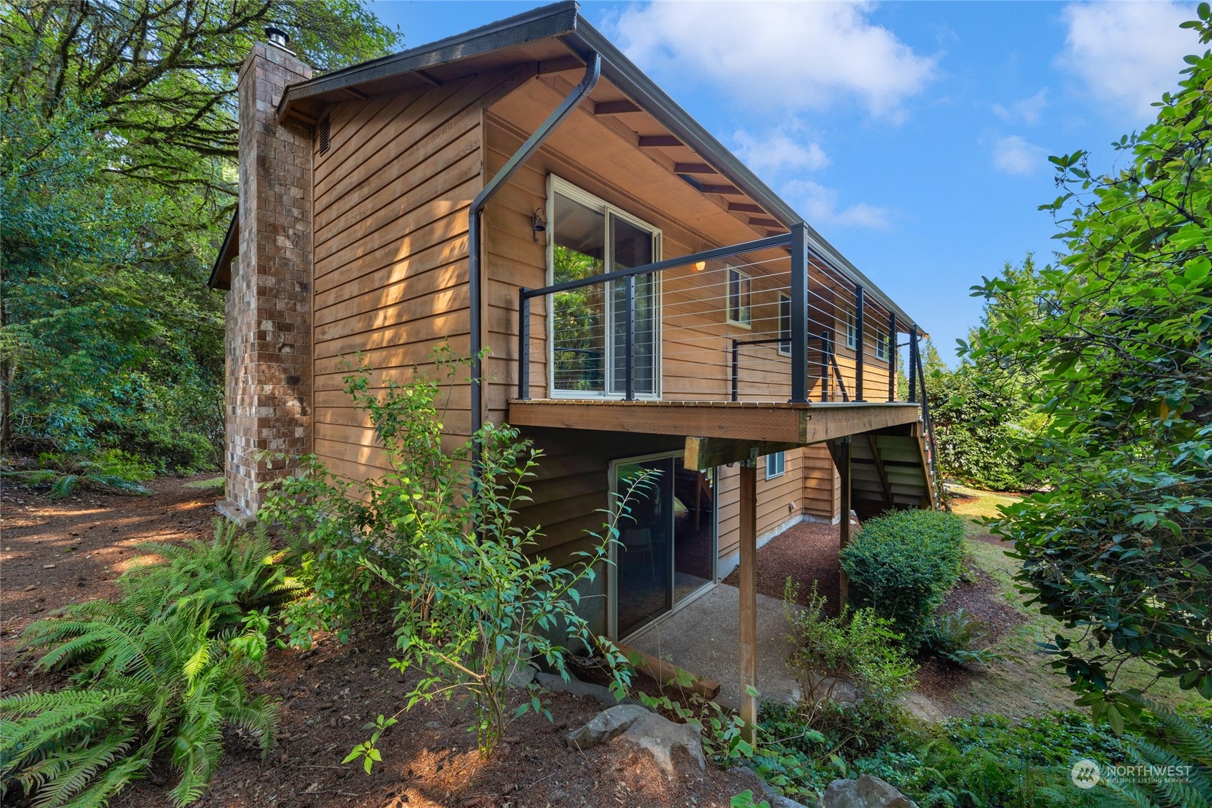 5616 227th Street Southeast Bothell, WA 98021 - Photo 11 of 38 a view of a house with brick walls and flower plants