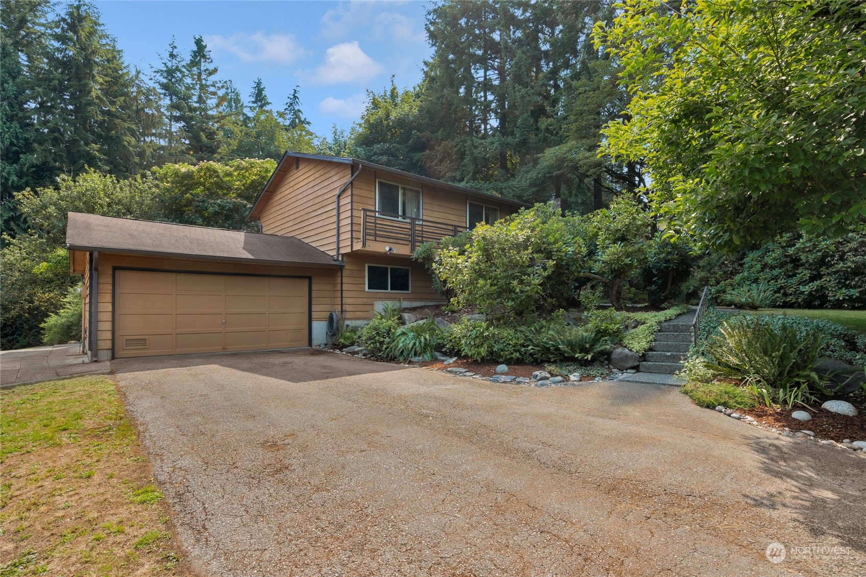 5616 227th Street Southeast Bothell, WA 98021 - Photo 2 of 38 a front view of a house with a yard and garage