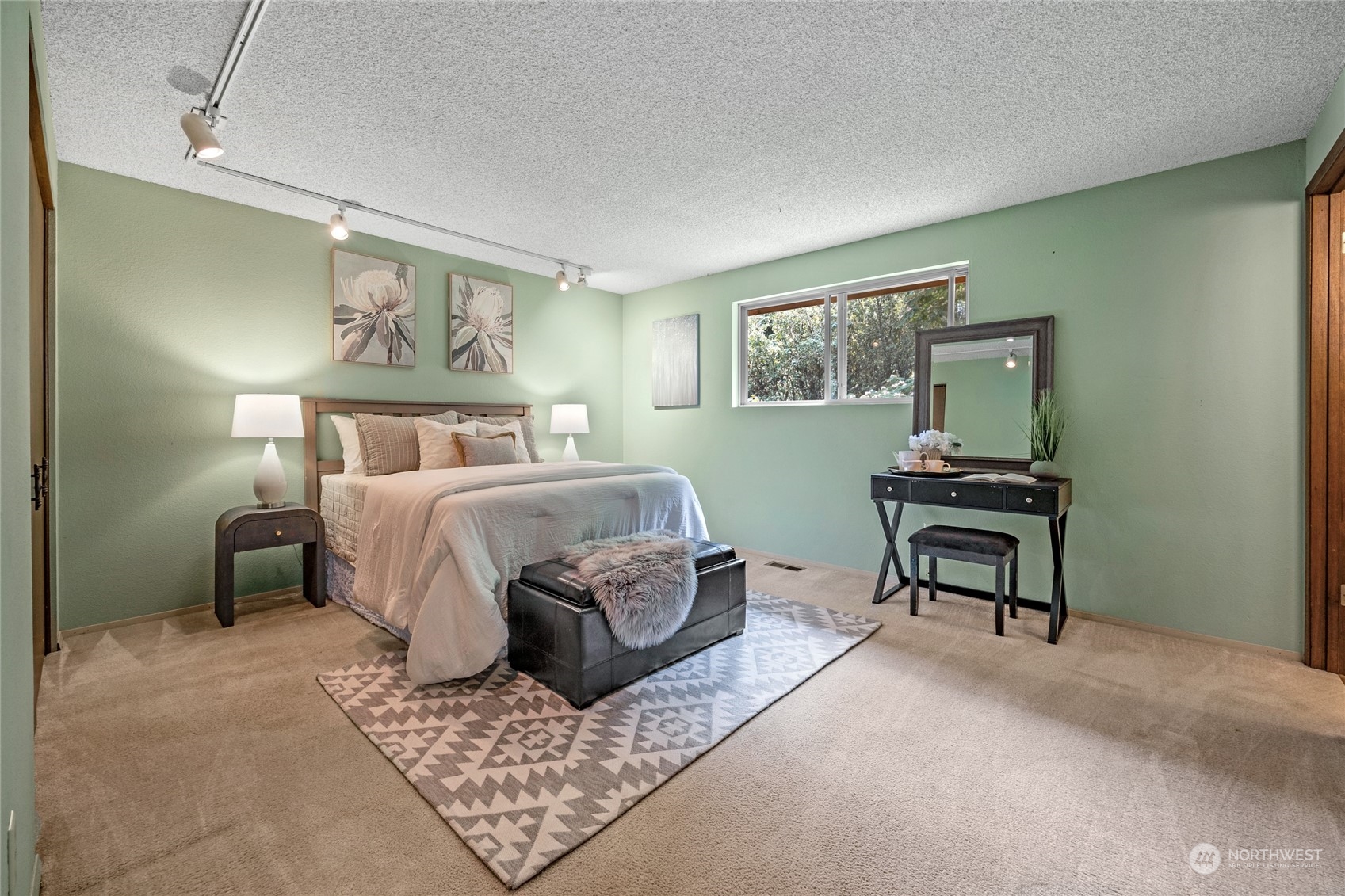 5616 227th Street Southeast Bothell, WA 98021 - Photo 25 of 38 a bedroom with a bed lamp and paintings on the wall