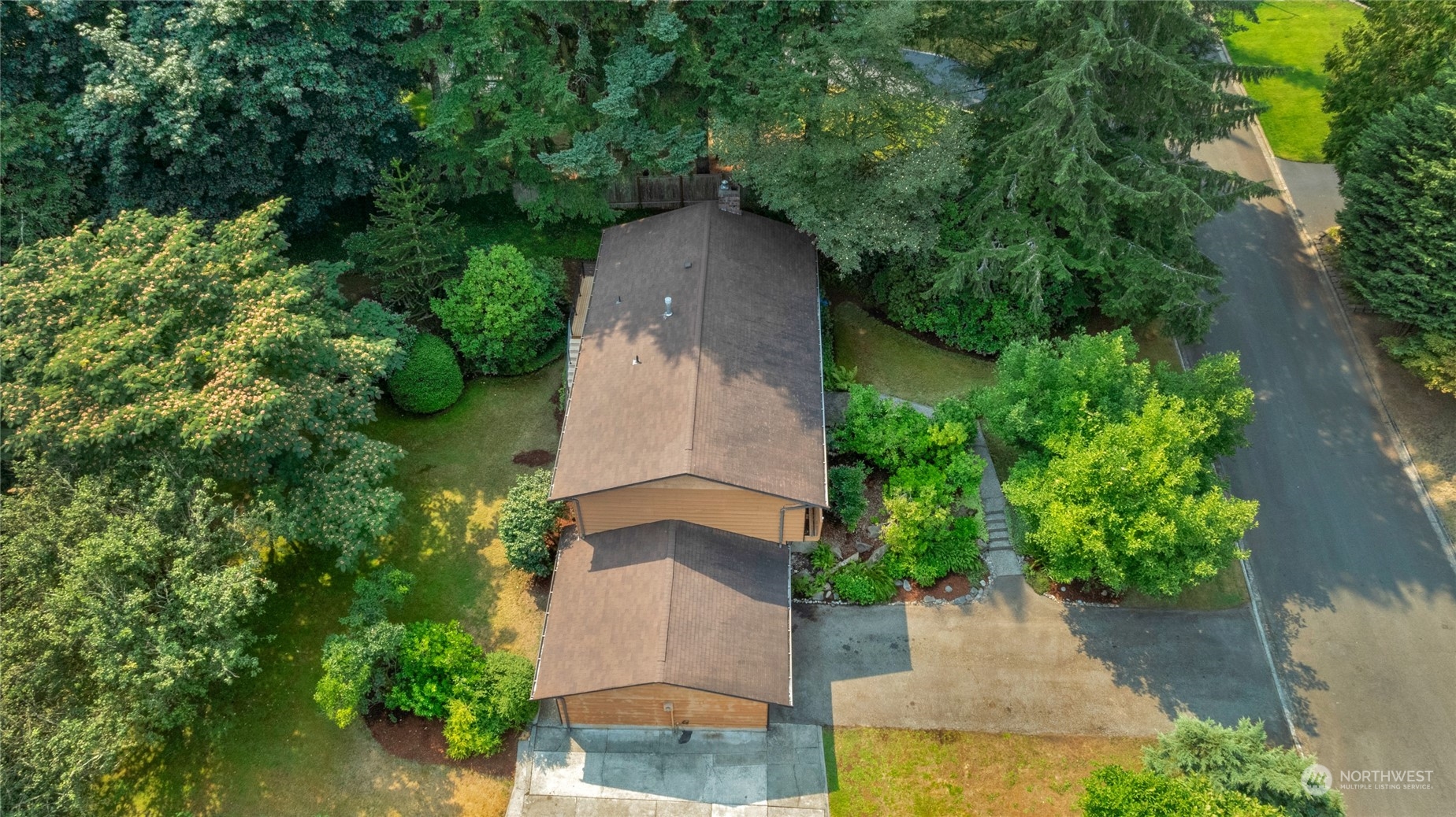 5616 227th Street Southeast Bothell, WA 98021 - Photo 6 of 38 an aerial view of a house with a yard and large trees
