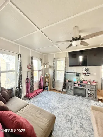 a bedroom with furniture and a flat screen tv