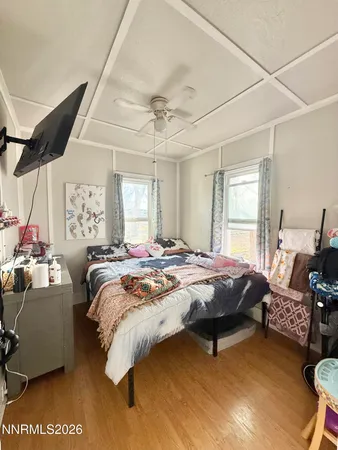 a bed sitting in a spacious bedroom next to a window
