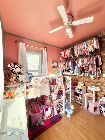 a bedroom with furniture and a large window