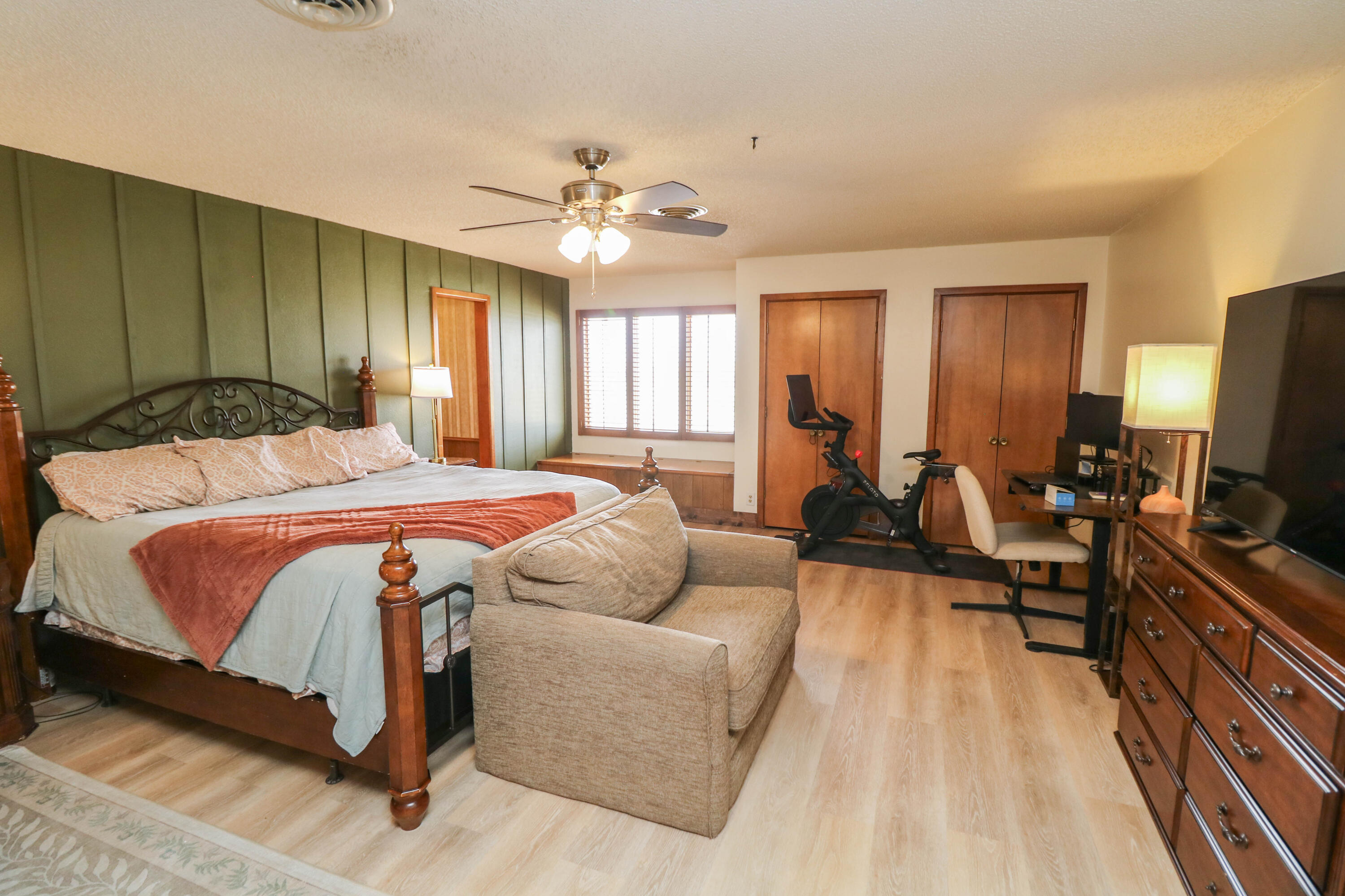 1740 Highway 70 Springlake, TX 79082 - Photo 15 of 39 a bedroom with a bed couch dresser and a flat tv screen