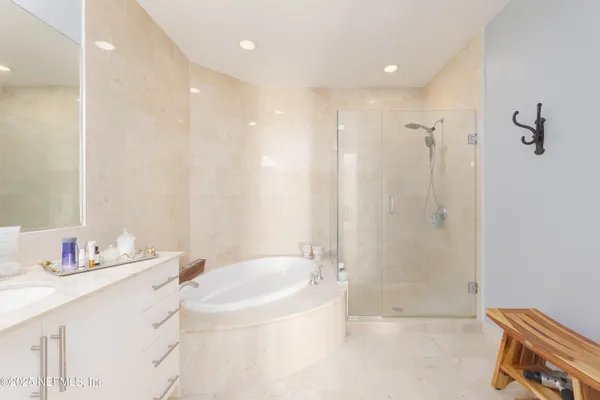 a large bathroom with a double vanity sink a toilet and a mirror
