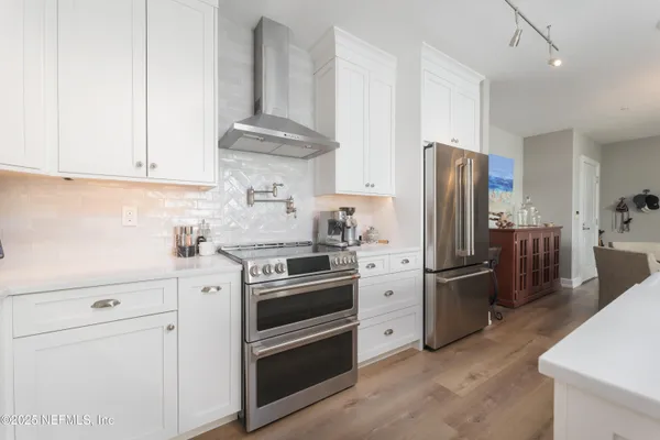 a kitchen with stainless steel appliances and white cabinets