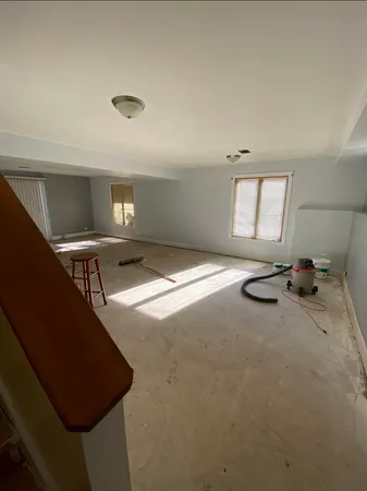 a view of a room with a ceiling fan