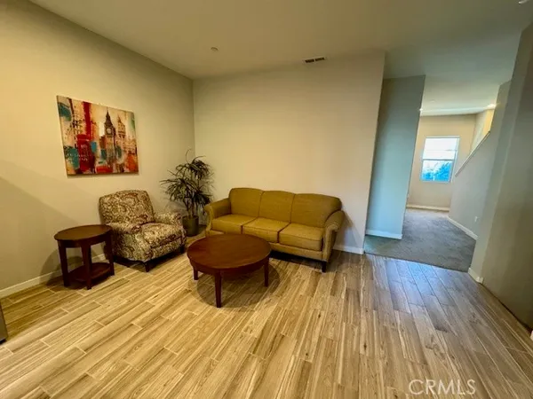 a living room with couches and painting on the wall