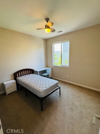 a bedroom with a bed and window
