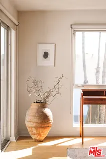 a vase of flowers sitting next to a window