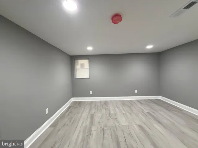 a view of room with window and wooden floor