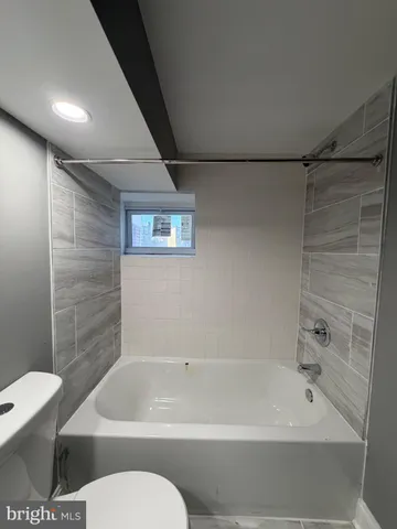 a bathroom with a toilet and a bathtub