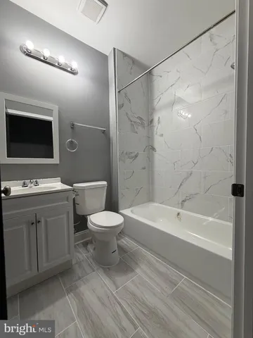 a spacious bathroom with a bathtub shower sink vanity and toilet