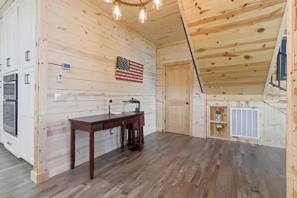 a view of a room with wooden floor