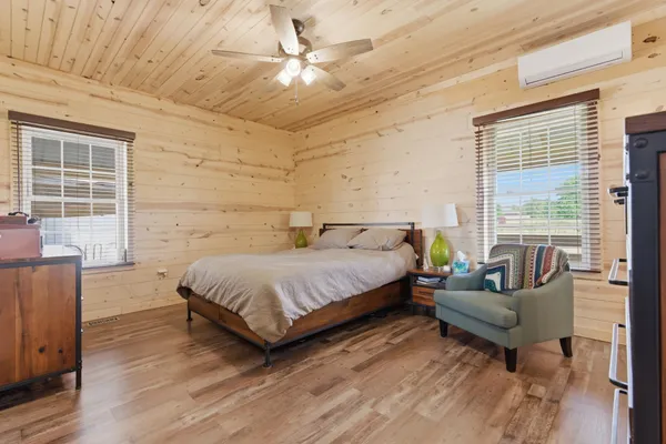 a spacious bedroom with a bed and a couch