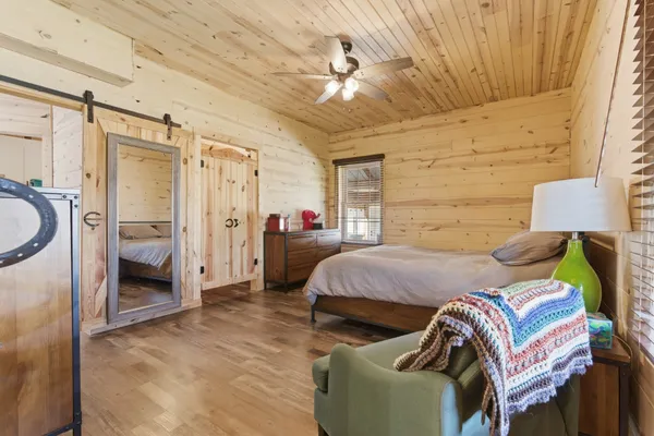 a bedroom with a bed and a couch