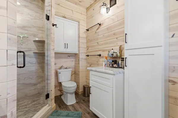 a bathroom with a toilet and a shower