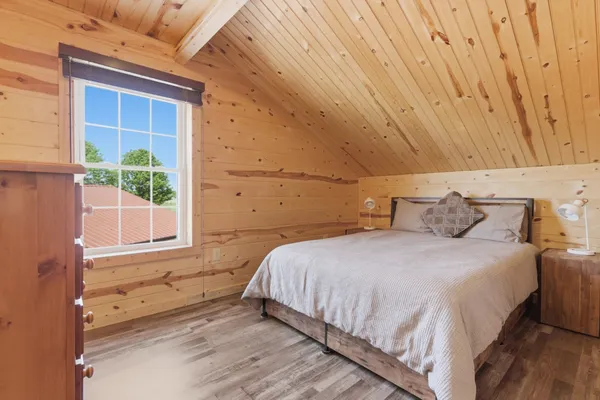 a bedroom with a bed and a window