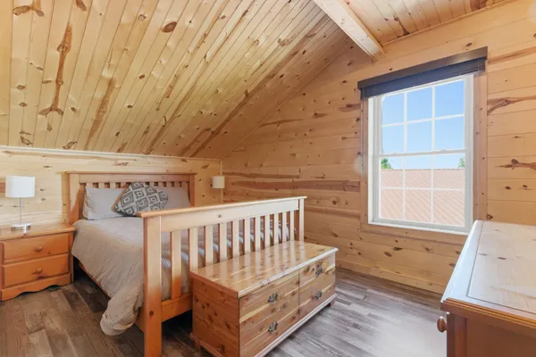 a bedroom with a bed and window