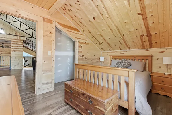 a view of a bedroom with wooden floor