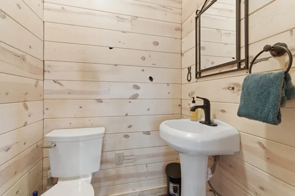 a bathroom with a sink toilet and mirror