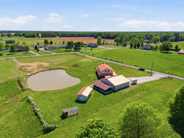 an aerial view of a house with garden space and ocean view