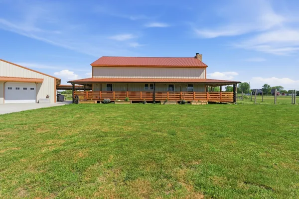 a view of a building with a yard and sitting area