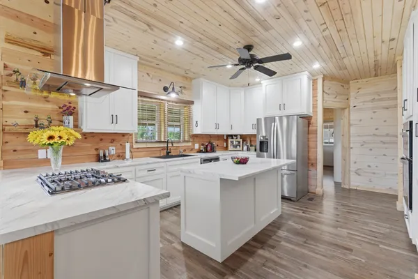 a kitchen view with white cabinets and refrigerator
