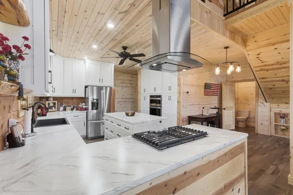 a kitchen with a stove and white cabinets