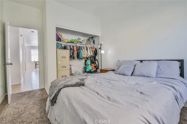 a bedroom with a bed and a large mirror