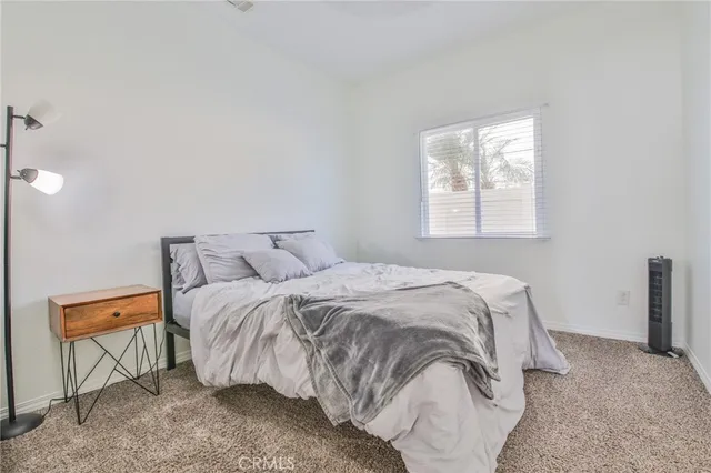 a bedroom with a bed and window