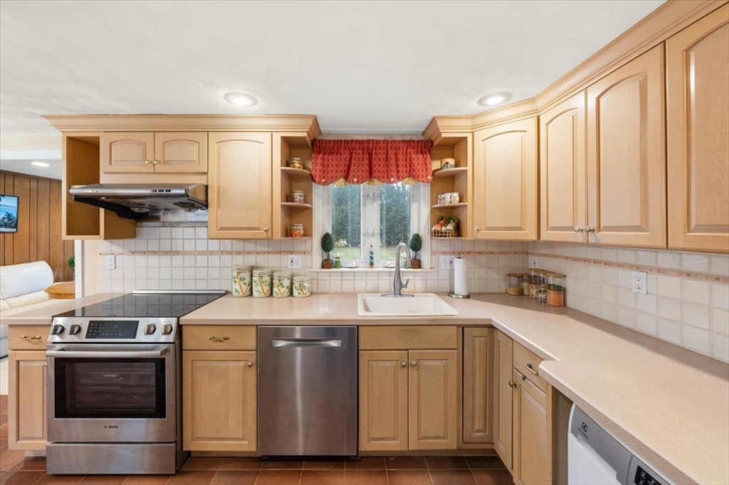 8 Stanley Street Natick, MA 01760 - Photo 11 of 35 a kitchen with stainless steel appliances a sink stove and cabinets