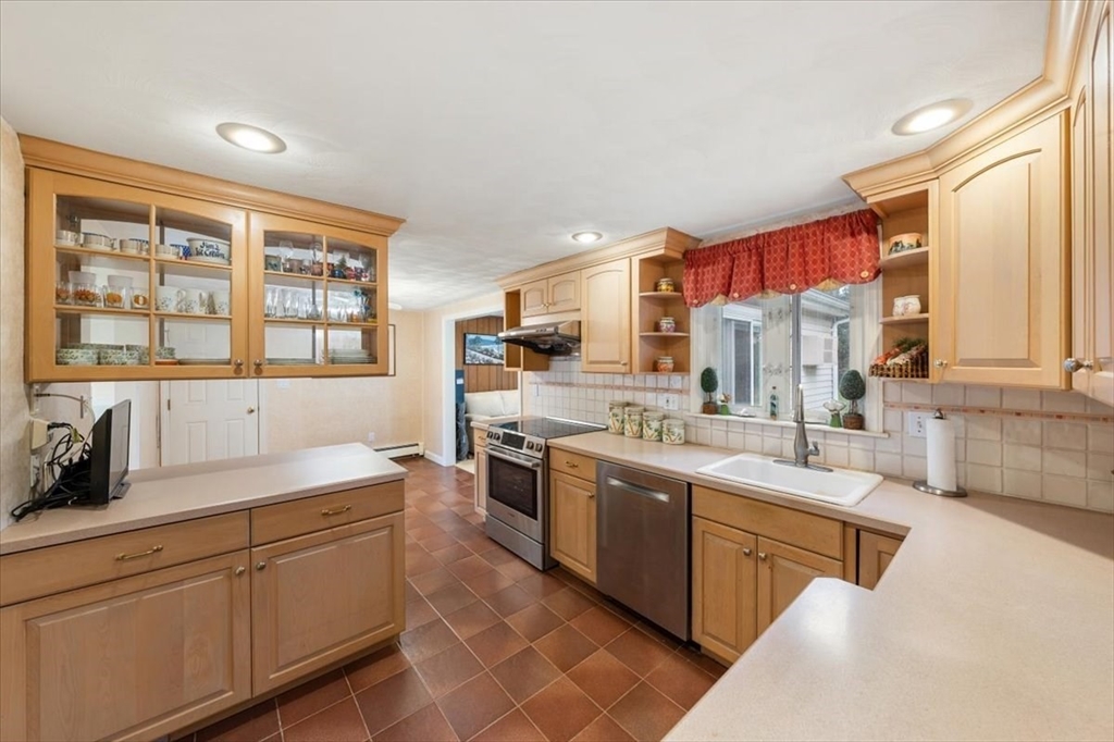 8 Stanley Street Natick, MA 01760 - Photo 12 of 35 a kitchen with stainless steel appliances a sink stove and cabinets