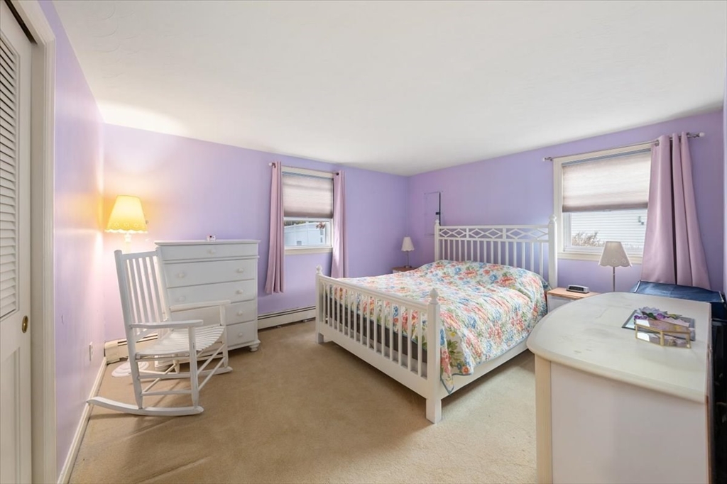 8 Stanley Street Natick, MA 01760 - Photo 16 of 35 a bedroom with a bed and a window