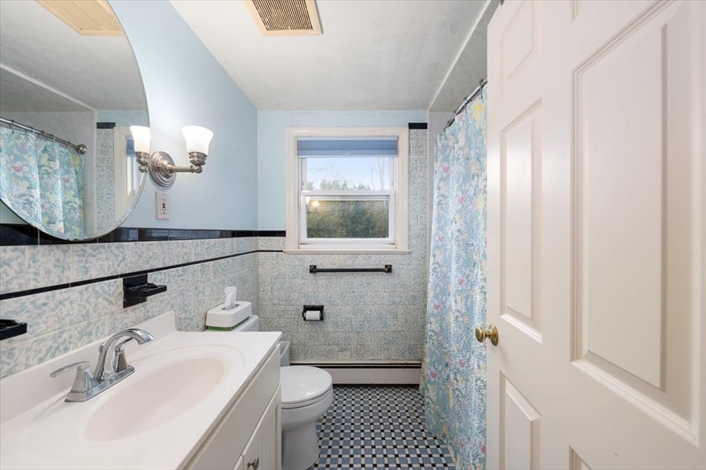 8 Stanley Street Natick, MA 01760 - Photo 17 of 35 a bathroom with a sink a toilet and shower