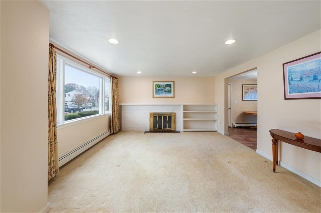 8 Stanley Street Natick, MA 01760 - Photo 3 of 35 a view of a livingroom with an empty space and a fireplace