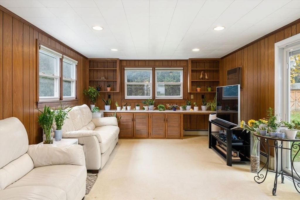 8 Stanley Street Natick, MA 01760 - Photo 6 of 35 a living room with furniture a flat screen tv and large window