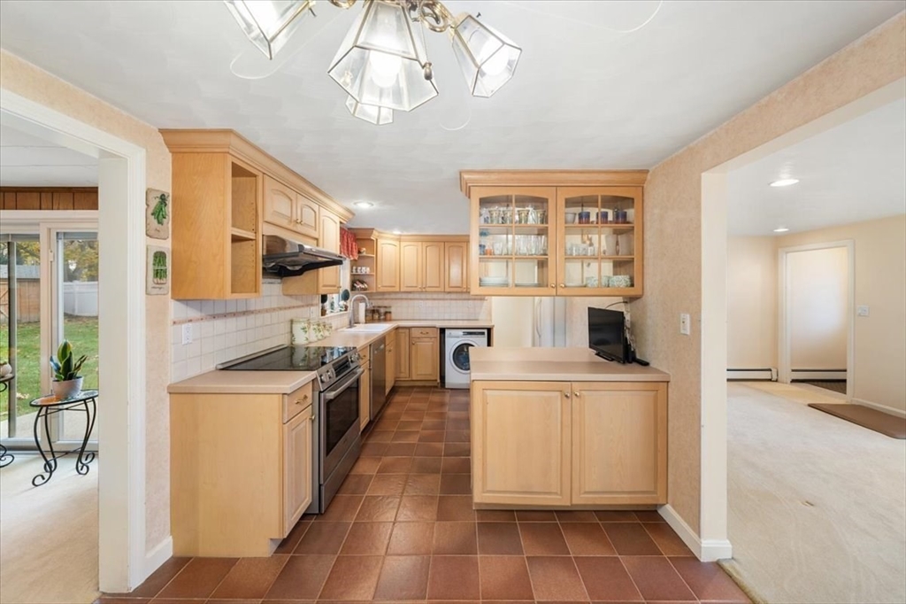 8 Stanley Street Natick, MA 01760 - Photo 8 of 35 a kitchen with stainless steel appliances granite countertop a sink a stove and a refrigerator