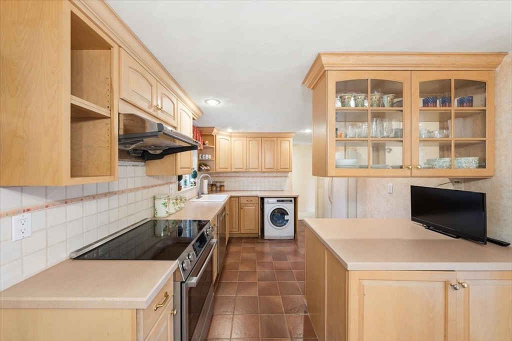8 Stanley Street Natick, MA 01760 - Photo 9 of 35 a kitchen with a sink a counter top space and stainless steel appliances
