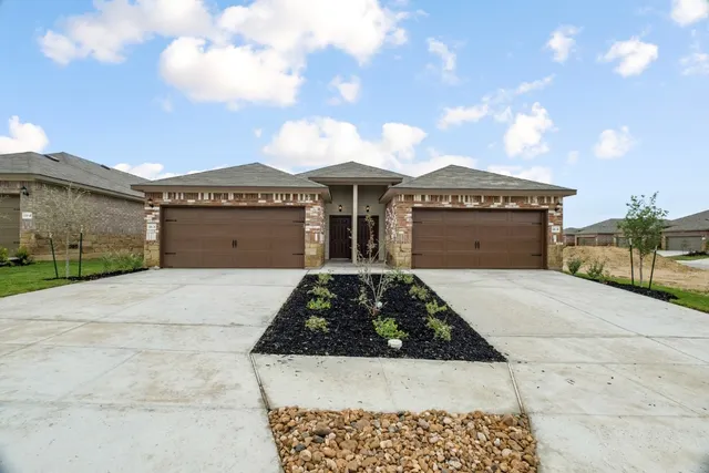 a view of a house with a yard and garage
