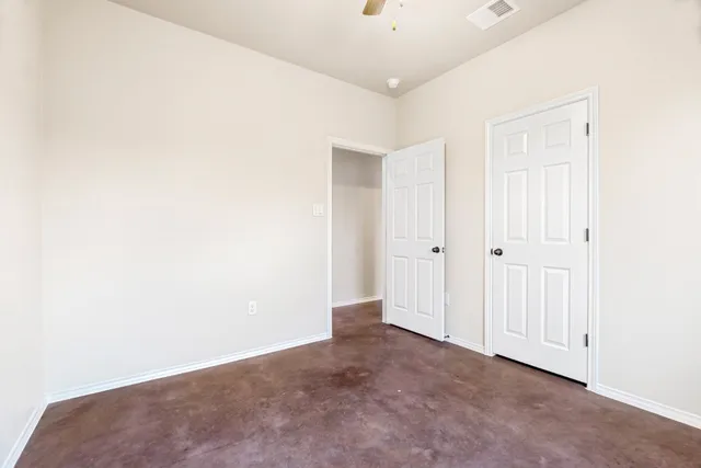 an empty room with a ceiling fan